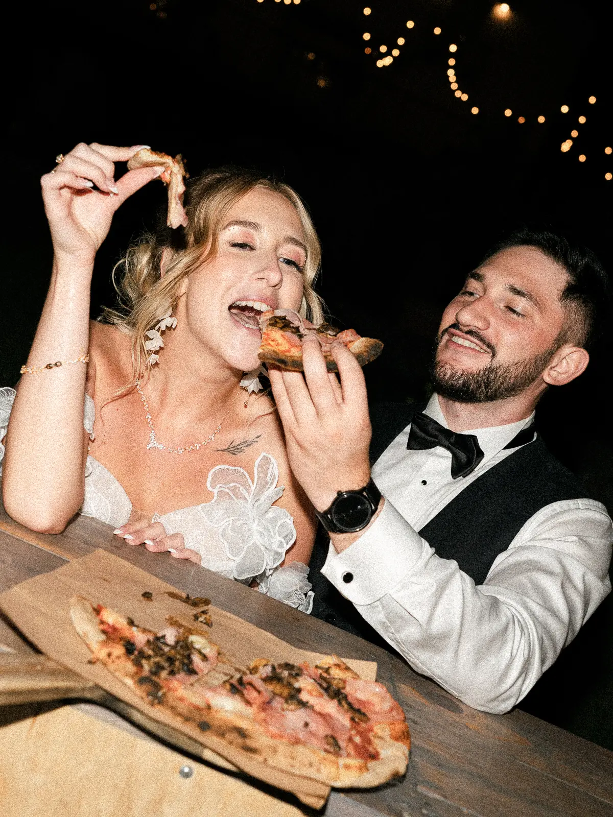 Natalia i Michał jedzą pizzę na weselnej imprezie nocą
